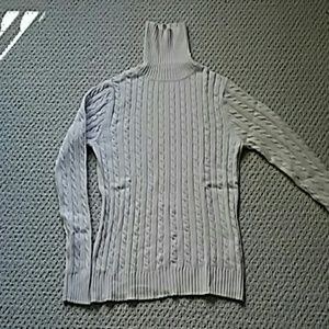 Knit sweater with cotton, nylon blend.
